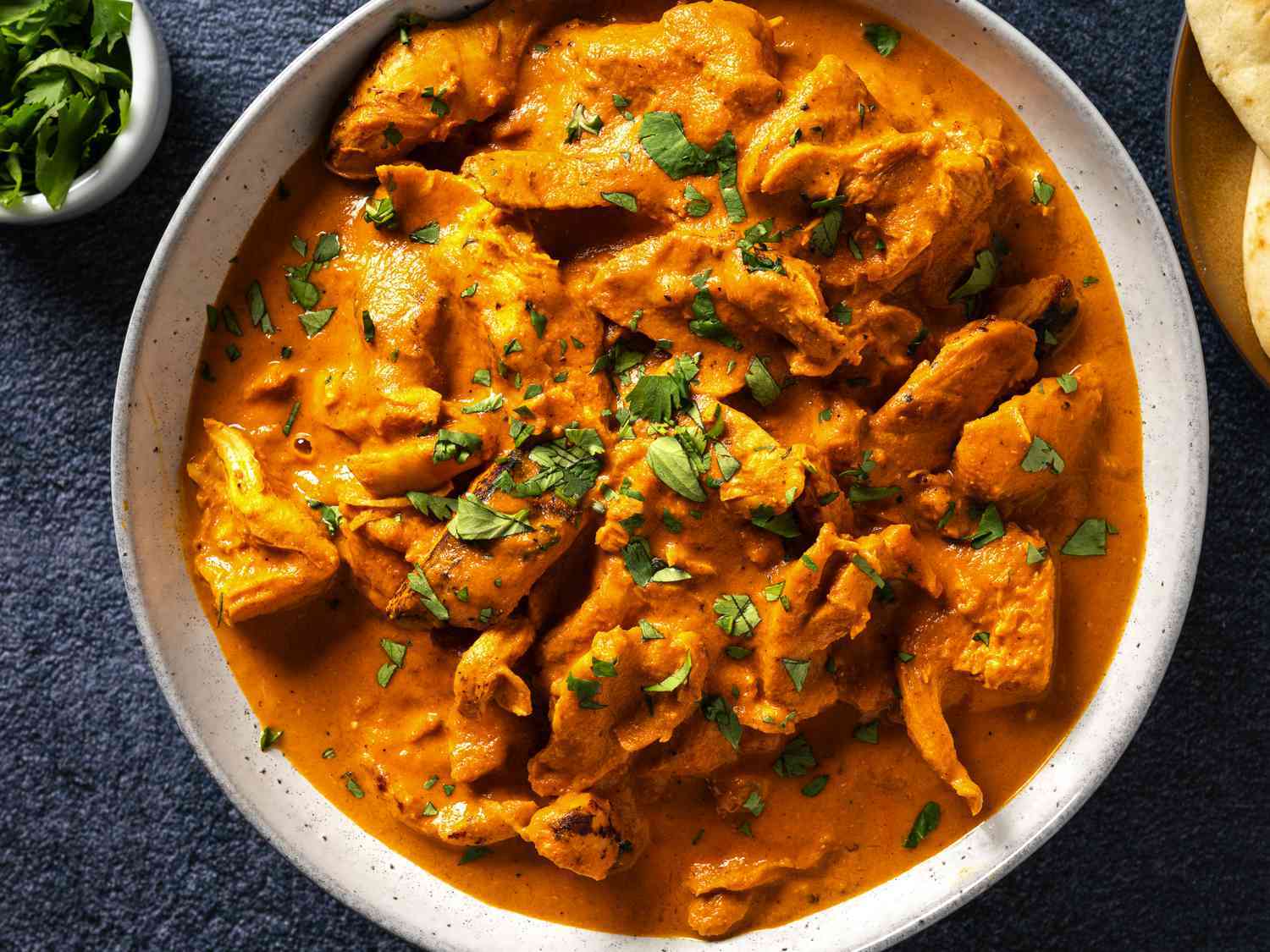 Chicken tikka masala served in a creamy orange curry