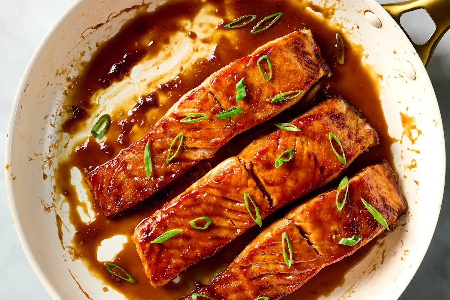 Tamarind-glazed salmon fillets in a glossy pan sauce