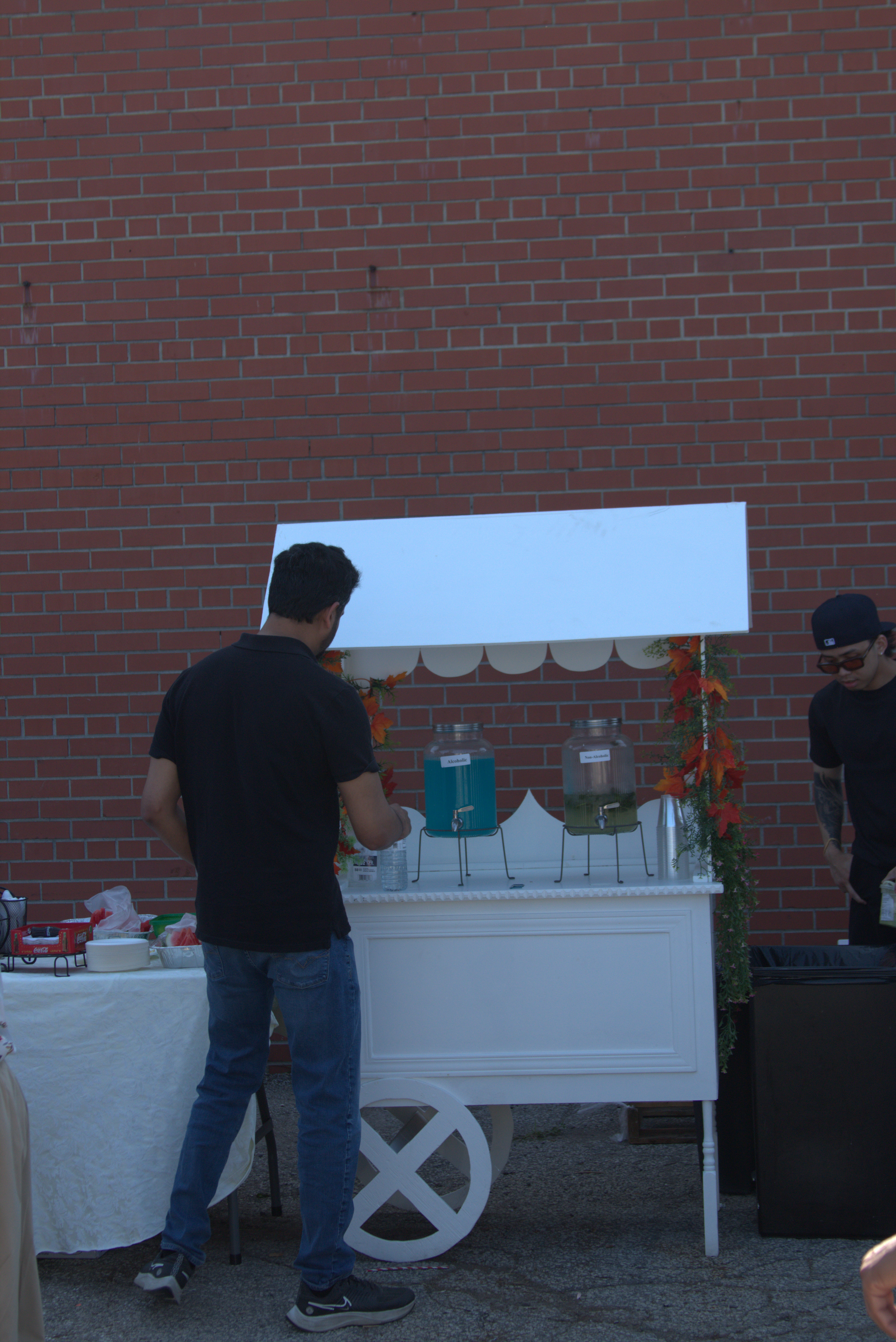 A styled refreshment cart prepared as part of an outdoor catered event setup