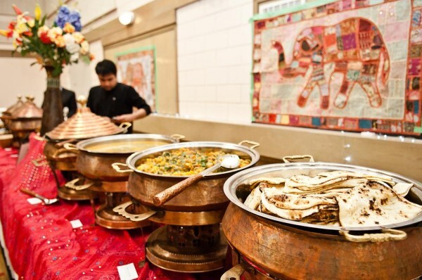 Copper chafer warmers and flatbreads arranged on a buffet line for a group meal service